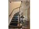 Staircase with carpet treads and a dark wood handrail at 1400 Tedford St, Eustis, FL 32726