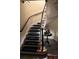 Staircase with carpet and wood railing at 1400 Tedford St, Eustis, FL 32726