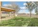 Large backyard with a covered patio and well-maintained lawn, great for Gathering gatherings and outdoor activities at 14806 Del Morrow Way, Orlando, FL 32824