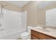 Bathroom features tiled shower, vanity and large mirror at 14806 Del Morrow Way, Orlando, FL 32824