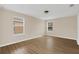 Bedroom featuring two windows allowing lots of natural light and wood-look floors at 14806 Del Morrow Way, Orlando, FL 32824