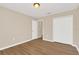 Bedroom with wood-look flooring and closet offers ample storage solutions at 14806 Del Morrow Way, Orlando, FL 32824