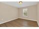 Bedroom with window and wood-look flooring offers a warm and inviting atmosphere at 14806 Del Morrow Way, Orlando, FL 32824