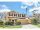 Inviting two-story home featuring a well-maintained lawn and a neutral color palette at 14806 Del Morrow Way, Orlando, FL 32824