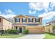 Inviting two-story home featuring a well-maintained lawn and a neutral color palette at 14806 Del Morrow Way, Orlando, FL 32824