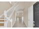Bright foyer with tile flooring and a staircase leading to the upper level at 14806 Del Morrow Way, Orlando, FL 32824