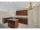Open kitchen features a kitchen island, granite countertops, and stylish lighting at 14806 Del Morrow Way, Orlando, FL 32824