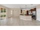 Open-concept kitchen and living area, with modern appliances and granite countertops at 14806 Del Morrow Way, Orlando, FL 32824