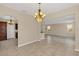 Open-concept living area with tile floors, neutral paint, and view to kitchen at 14806 Del Morrow Way, Orlando, FL 32824