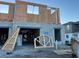 New construction of a two-story home featuring concrete blocks and wood framing, showcasing a work-in-progress residential structure at 14906 Harvest St, Orlando, FL 32824