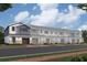 Exterior elevation of new construction townhomes with attached garages and professionally landscaped yards at 14906 Harvest St, Orlando, FL 32824