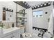 Charming bathroom with black and white tiling, a window, a tub, and a sleek vanity at 151 N Orlando Ave # 229, Winter Park, FL 32789