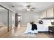Bedroom with a mirror closet, ceiling fan, light walls, and a patterned rug at 151 N Orlando Ave # 229, Winter Park, FL 32789