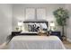 Cozy bedroom featuring bedside tables, lamps, decorative pillows, and a plush duvet at 151 N Orlando Ave # 229, Winter Park, FL 32789