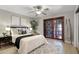 Serene bedroom featuring a ceiling fan, neutral walls, a stylish area rug, and a comfortable bed at 151 N Orlando Ave # 229, Winter Park, FL 32789