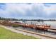 Waterfront view of the wooden dock stretching out into the water with several boats at 151 N Orlando Ave # 229, Winter Park, FL 32789