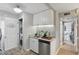 Bright kitchen with sleek cabinetry, granite countertops, stainless steel appliances, and adjacent laundry room at 151 N Orlando Ave # 229, Winter Park, FL 32789