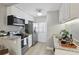 Charming kitchen featuring stainless steel appliances, granite countertops, and bright white cabinetry at 151 N Orlando Ave # 229, Winter Park, FL 32789