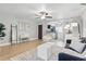 Bright living area with tile floors, a modern rug, and an open flow to the adjacent kitchen at 151 N Orlando Ave # 229, Winter Park, FL 32789