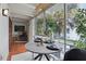 Bright sunroom featuring a round dining table, comfortable chairs, and scenic views from large windows at 151 N Orlando Ave # 229, Winter Park, FL 32789