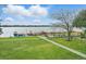 Beautiful waterfront property with lush green lawn, lounge chairs, grilling area, and boat docks at 151 N Orlando Ave # 229, Winter Park, FL 32789