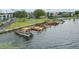 Overhead shot of the waterfront showing the docks, boats, green grass, and community pool at 151 N Orlando Ave # 229, Winter Park, FL 32789