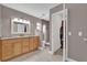 Bathroom featuring double sinks, a shower, and a door to the closet at 1585 Randolph St, Deltona, FL 32725