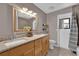 Bright bathroom features double sink vanity with granite countertops, and a framed mirror at 1585 Randolph St, Deltona, FL 32725