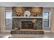 A stunning stone fireplace serves as a focal point, complemented by decorative items on the mantel at 1585 Randolph St, Deltona, FL 32725