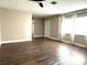 Bright living room with ceiling fan, wood floors, and natural light from the large windows at 1962 E Chapel Dr, Deltona, FL 32738