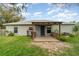 The backyard features a covered patio, lush lawn, and diverse plants, ideal for outdoor enjoyment at 1967 Villa Angelo Blvd, St Cloud, FL 34769