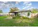 The backyard features a covered patio, lush lawn, and diverse plants, ideal for outdoor enjoyment at 1967 Villa Angelo Blvd, St Cloud, FL 34769