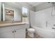 Bright bathroom features a shower and tub combination, vanity and window for natural light at 1967 Villa Angelo Blvd, St Cloud, FL 34769