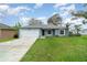 Charming single-story home featuring a well-manicured lawn, a one car garage, and a welcoming entrance at 1967 Villa Angelo Blvd, St Cloud, FL 34769