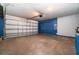 Spacious garage with a garage door and blue accent wall, offering ample storage space and functionality at 1967 Villa Angelo Blvd, St Cloud, FL 34769