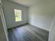 Cozy room featuring wood floors, neutral walls, and a bright window at 2209 Sw 178Th St, Ocala, FL 34473