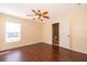 Well-lit bedroom with a window, ceiling fan and an open doorway to a bathroom for convenience at 2260 The Oaks Blvd, Kissimmee, FL 34746
