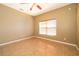 Bedroom with neutral walls, a ceiling fan and a window with blinds allowing natural light into the room at 2260 The Oaks Blvd, Kissimmee, FL 34746