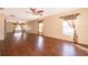 Large open living room with wood floors, neutral walls, natural light, and stylish window coverings at 2260 The Oaks Blvd, Kissimmee, FL 34746