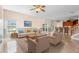 Open floor plan featuring tile floors, a ceiling fan, and a view into the kitchen at 2260 The Oaks Blvd, Kissimmee, FL 34746