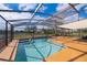 Screened-in pool and deck, featuring a built-in hot tub and overlooking a scenic lake view at 2260 The Oaks Blvd, Kissimmee, FL 34746