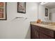 Cozy bathroom with granite counters, a sink, and dark cabinets, showcasing a well-maintained space at 2478 Pillar Coral Dr # S, Orlando, FL 32808