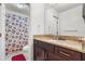 Bathroom features a granite countertop, vanity, and shower with a floral curtain at 2478 Pillar Coral Dr # S, Orlando, FL 32808