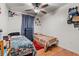 Cozy bedroom featuring two twin beds, hardwood floors, and a ceiling fan at 2478 Pillar Coral Dr # S, Orlando, FL 32808