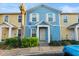 Charming two-story townhouse with blue and yellow exterior and well-maintained landscaping at 2478 Pillar Coral Dr # S, Orlando, FL 32808