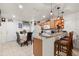 Bright kitchen features a breakfast bar with granite countertops, wooden cabinets, and decorative pendant lighting at 2478 Pillar Coral Dr # S, Orlando, FL 32808