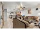 Open-concept living room with a view of the kitchen, featuring comfortable seating and modern decor at 2478 Pillar Coral Dr # S, Orlando, FL 32808