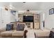 Inviting living room with comfortable sofas, a ceiling fan, and a decorative entertainment center with glass accents at 2478 Pillar Coral Dr # S, Orlando, FL 32808
