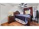 Elegant bedroom featuring a wooden bed frame, matching nightstand, and hardwood floors at 2478 Pillar Coral Dr # S, Orlando, FL 32808
