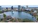 Stunning aerial view of a tranquil lake featuring a fountain, framed by a dynamic cityscape backdrop at 260 S Osceola Ave # 601, Orlando, FL 32801